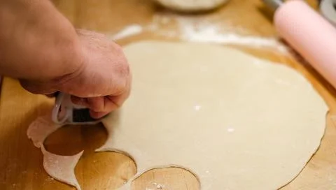 A mans hands rolling out dough Stock Photos
