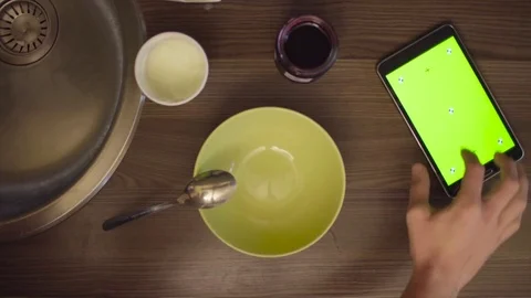Man's hands scrolling the tablet with green screen Stock Footage