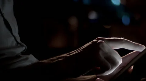 Man's hands scrolling tablet night pan Stock Footage 69272100