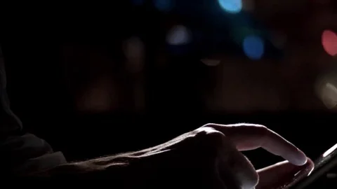 Man's hands scrolling tablet night pan Stock Footage 69272683