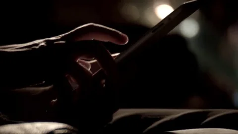 Man's hands scrolling tablet night tilt up Stock Footage 69272973