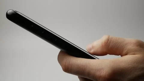 Man's hands scrolling through an online video library on a smartphone. Stock Footage 301699469