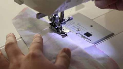Man's hands is sewing on the sewing machine Stock Footage 69912234