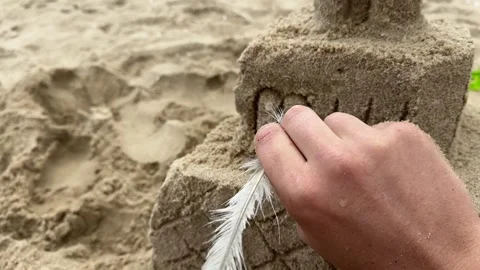 Man's hands shaping wet sand beach Stock Footage 277135699