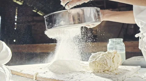 Mans hands sifting flour through a sieve for baking Stock Footage