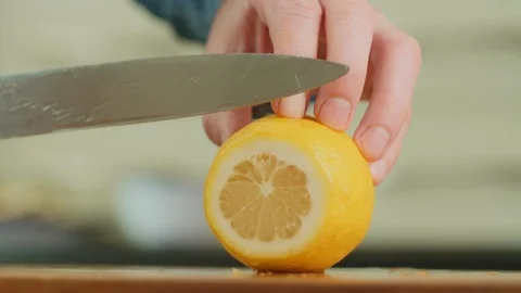 Man's Hands Slicing Lemon With Knife On Chopping Board Stock Footage 86069986