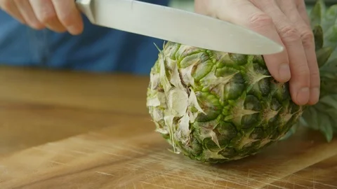 Man's Hands Slicing Pineapple With Knife On Chopping Board Stock Footage 86115275