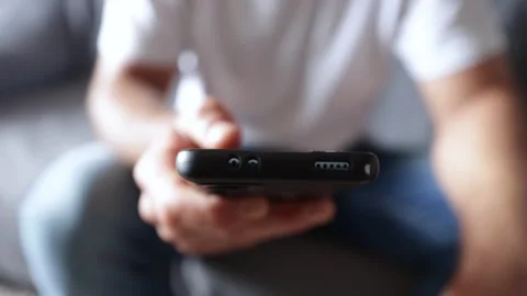 Man's hands sliding on the touch screen of a mobile phone Stock Footage 244192700