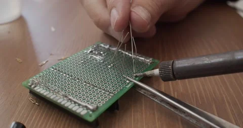 Man's hands soldering an electronic board Stock Footage 130519271
