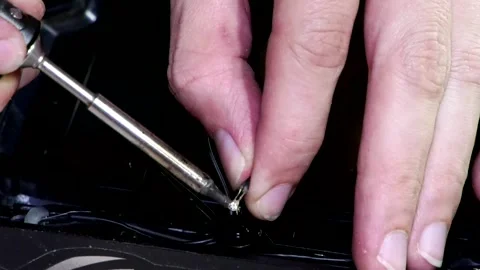 A man's hands soldering wires while repairing a computer. Video stock 346882041