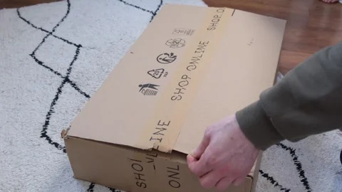 A mans hands with a stationery knife opens and cuts a mailbox close-up. The guy Stock Footage 309669794