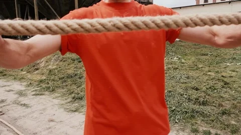 Mans hands stretching a rough rope, tough training 스톡 동영상 204007274