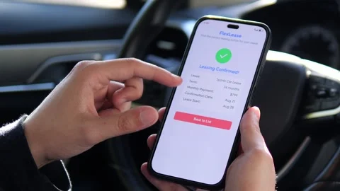 A mans hands study the successful approval notification for a car lease Stock Footage 315649377