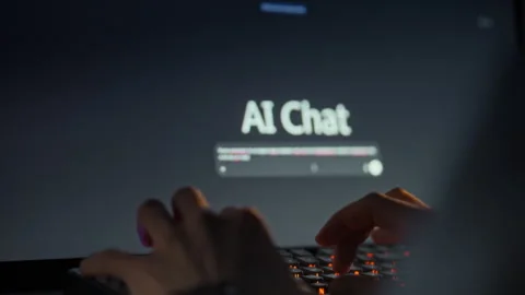 The mans hands swiftly enter a query into a computer chat interface engaging Stock Footage 334075716