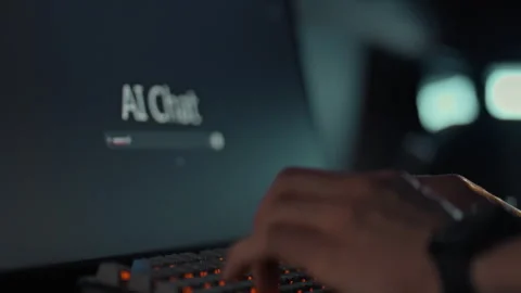A mans hands swiftly type a query into the chat window on the monitor intera Stock Footage 331314404