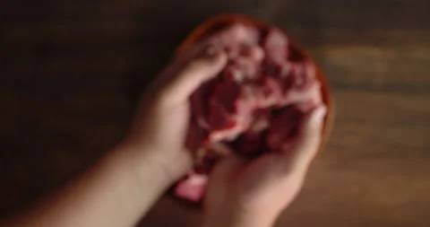 The man's hands take the pieces of raw beef off the plate. Stock Footage 139151846