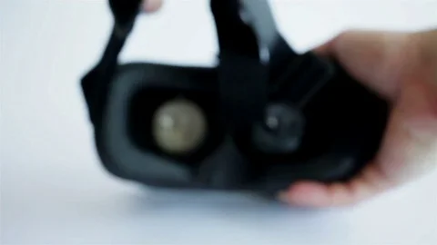 Mans hands take virtual reality glasses, vr and wear them, white background Stock Footage 76448488