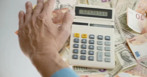 Man`s hands taking away paper currency and calculator and putting mobile device Stock Footage 132284673