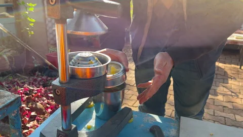 Mans hands taking squeezed orange juice and pouring in a cup Stock Footage 233105071