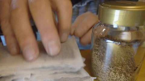 Man’s hands taking teabags and coffee from a cupboard. Video stock 129169243