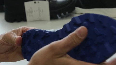 Man's hands testing sole and shoe. Close-up Stock Footage 82120828