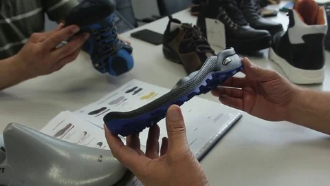 Man's hands testing sole and shoe Stock Footage