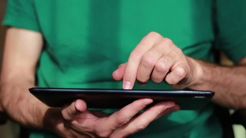 Man's hands thumbing through a tablet Vídeos de archivo 73506239