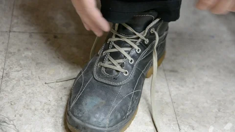Mans hands tie shoelaces on work boots. safety concept. Video stock 99766199