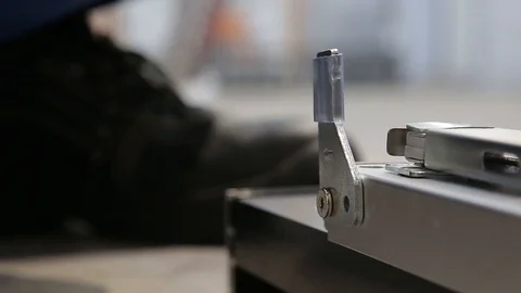Mans hands tighten screw during assembling furniture doors system. Close up view Stock Footage 122855331