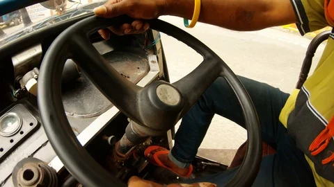 Man's hands turn steering wheel of mouving autorickshaw Stock Footage 96323135