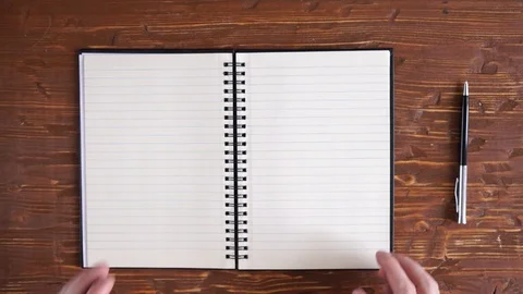 Man's hands turning over clean blank pages from recycled paper in big notebook Video stock 106341053