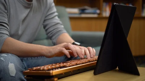Man's hands types text with retro style keyboard and Fire HD tablet Stock Footage 121638173