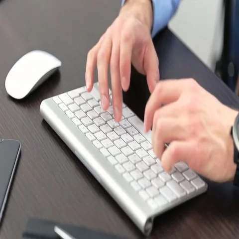 Man's hands typing on computer keyboard Stock Footage 69668359