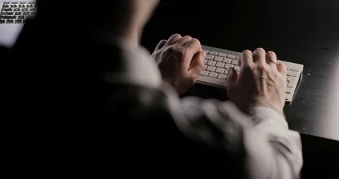 Man's hands typing on the keyboard sitting at the table on workplace. Stock Footage 105302608