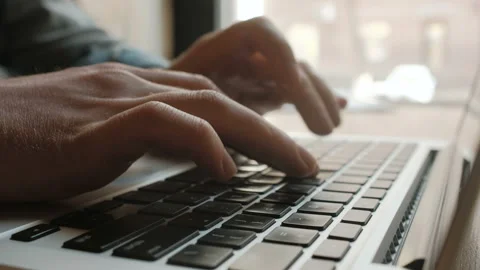 Man's hands typing on laptop keyboard Stock Footage 164945125