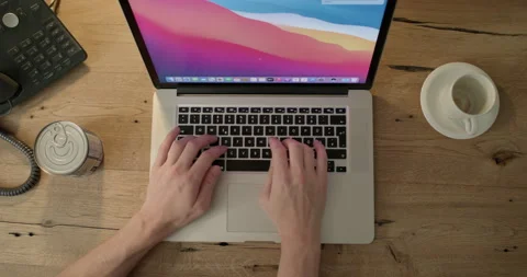 A man's hands typing on a laptop keyboard Stock Footage 238833583