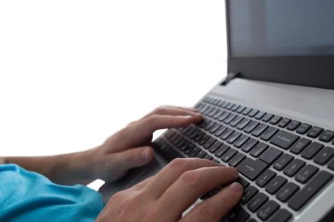 Man's hands typing on laptop notebook keyboard isolated on white background. Man Foto stock