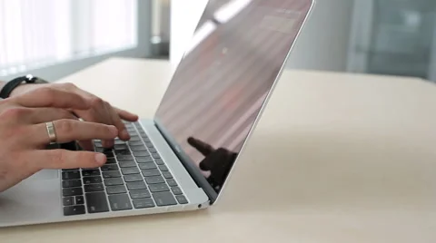 The man's hands typing on the laptop in the office Stock Footage 65302008
