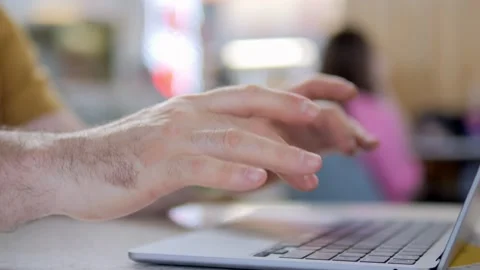 Man's hands typing on laptop with shallow depth of field Stock Footage 343583176
