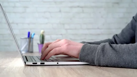 Man's hands typing on notebook keyboard Stock Footage 148391471
