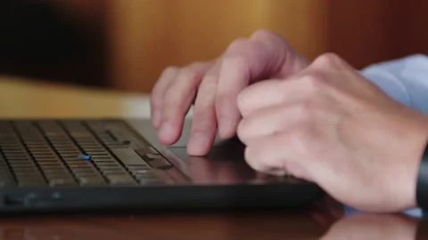 Man's hands typing on a PC notebook laptop computer and scrolling on trackpad Видео 143217398