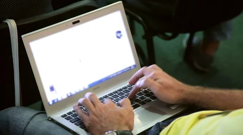 Man's hands typing text on laptop keyboard Stock Footage 64998654