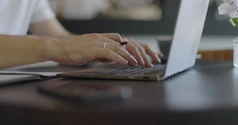 Man's hands typing text on laptop keyboard and using smart watch. Guy using Video stock 164491697