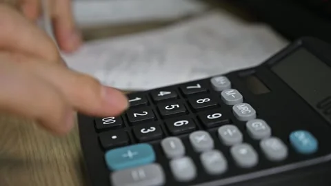 Man's hands using a calculator. Tax time.Tax concept. Close-up. Stock Footage 255995888