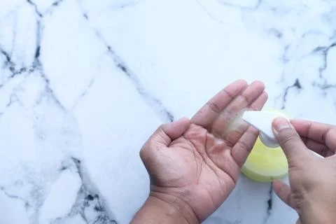 Man's hands using hand sanitizer gel, Top view Stock Photos