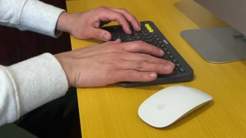 Man's hands using a keyboard and mouse Stock Footage 267210690