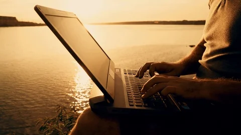 Man's hands using laptop computer on top of a hill by the river. 스톡 동영상 93979710