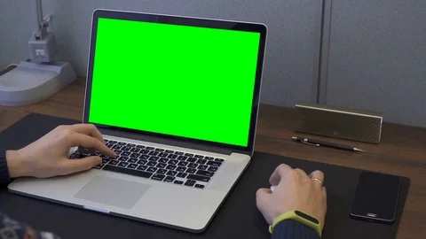 Man's hands using laptop with green screen on table Stock Footage 70719284