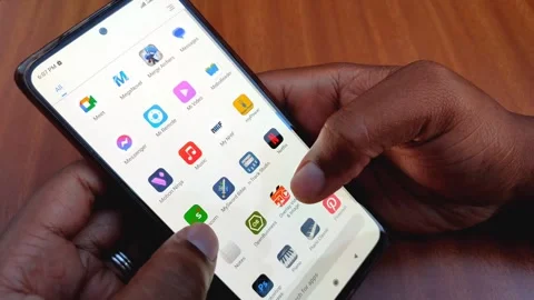 A Man's Hands Using Safaricom App to Send Money Stock Footage 255653453