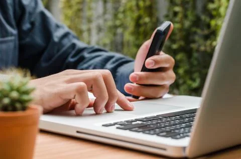 Man's hands using smart phone . view of business man hands busy using cell .. Stock Photos